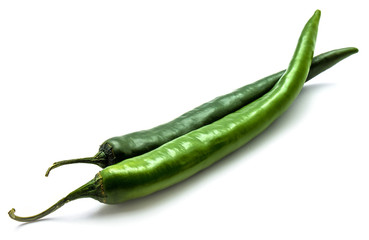 Two whole Chili peppers, green Cayenne, isolated on white background