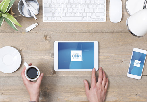 Top View Mockup of Tablet User at Wooden Desk with Smartphone and Espresso