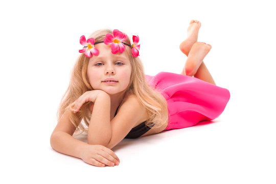 Cute pretty little girl in black bikini, pink skirt and pink wreath