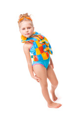 Beautiful little girl in in blue swimming suit and colorful life jacket