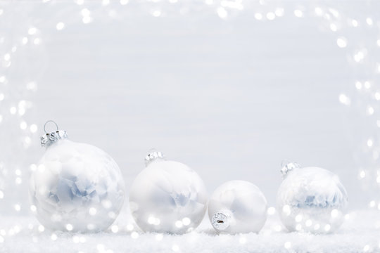 Silver Christmas balls on shiny background.