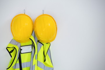 Close-up of protective workwear hanging on hook