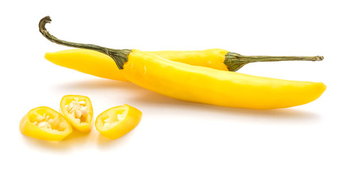 Two whole yellow Chili peppers and three slices isolated on white background