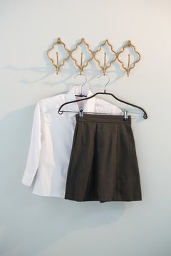 Formal shirt and skirt hanging on hook