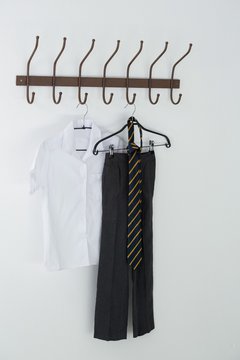 Formal shirt, tie and pants hanging on hook
