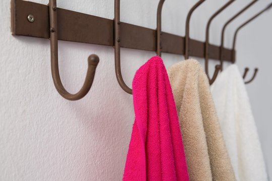 Close-up of colorful towels hanging on hook
