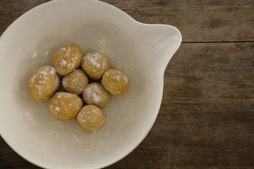 Round dough balls kept in a bowl
