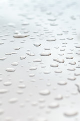 texture of a drop of water on a white glossy surface