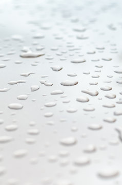 Texture Of A Drop Of Water On A White Glossy Surface