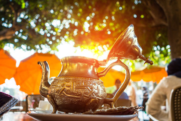 Close up of a moroccan tea pot against sun light
