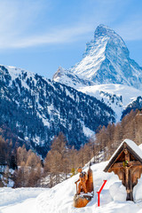 Scenic view on snowy Matterhorn peak in sunny day with blue sky.  Switzerland
