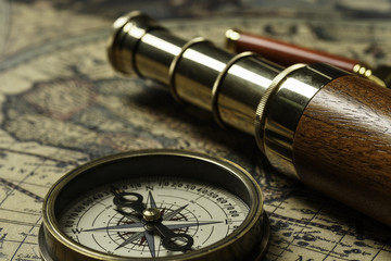 Retro compass with old map and spyglass