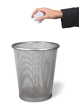 Hand Throwing a Crumpled Paper in a Waste Basket