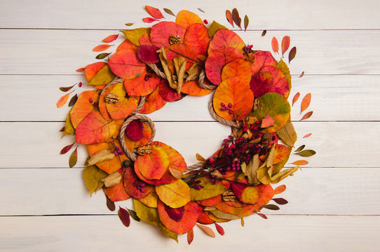 Autumn wreath from fallen leaves on wood