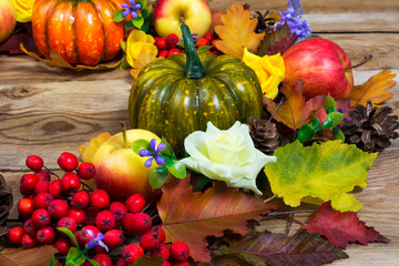 Thanksgiving wreath with colorful leaves, pumpkin, lilac flowers, close up