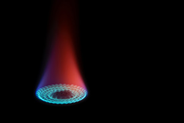 Gas stove with blue and red flame in the dark