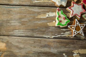 Gingerbread cookies arranged on wooden plank