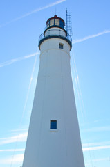 A tall lighthouse protects the river entrance for ships entering from the lake