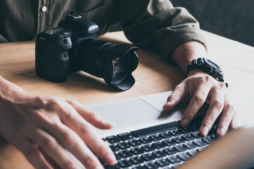 Close up of photographer editing his images on laptop.