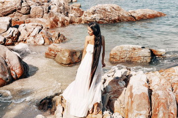 beautiful young boho style woman in white dress
