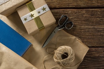 Paper with gift box by scissor and thread spool