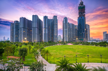 Fototapeta premium Ho Chi Minh City, Vietnam - November 30th, 2017: Panoramic skyscrapers at sunset with sky impressive in apartment, architectural extended life material development people in Ho Chi Minh City, Vietnam