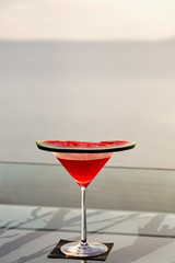 A glass of watermelon cocktail and evening sunlight 