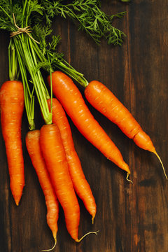 Fresh Organic Carrots on wooden background