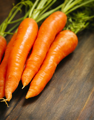 Fresh Organic Carrots on wooden background