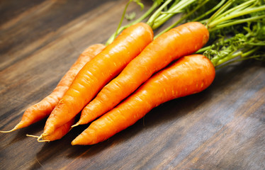 Fresh Organic Carrots on wooden background