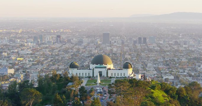 The Griffith Observatory and LA skyline in the distance in Los Angeles, California.