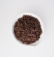 Chocolate chip morsels spread on a background.