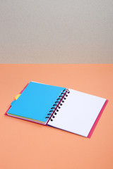 Open notebook with blue bookmark on a colored background