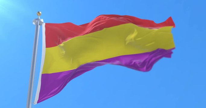 Flag of the Republic of Spain waving at wind with blue sky, loop