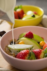 Milk being poured into bowl of breakfast cereal