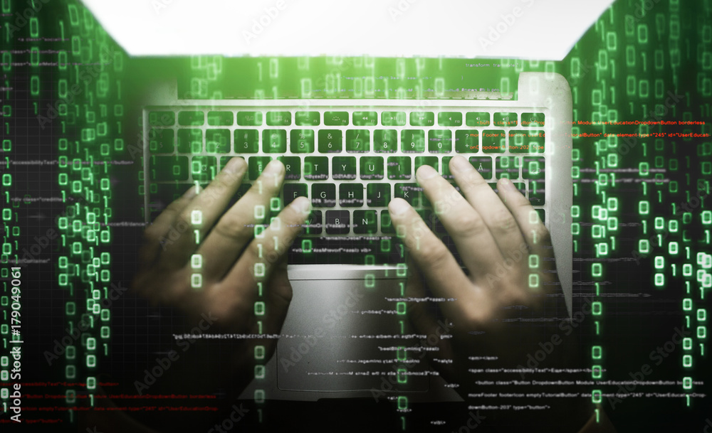 Poster hacker at work on laptop keyboard