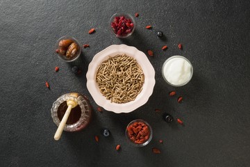 Bowl of cereal bran stick, yogurt, honey and dried fruits