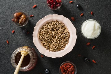 Bowl of cereal bran stick, yogurt, honey and dried fruits
