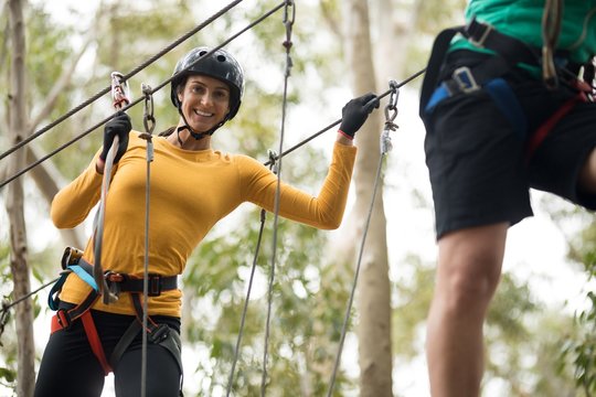 Woman enjoying zip line adventure in park