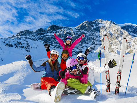 Skiing family enjoying winter vacation on snow in sunny cold day in mountains and fun. Solda, Italy.