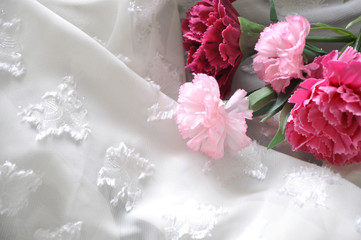 Artificial Pink Carnation on White Fabric