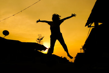 Fototapeta na wymiar Silhouette Of Jumping Kids Against Sunset