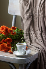 Autumn still life with coffee, homemade biscuits vanilla crescents, chrysanthemums and plaid.