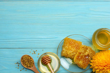 healthy background. honey, honeycomb, lemon, ginger on blue wooden table. Top view with copy space