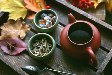 Obraz na płótnie Canvas Autumn tea, Teapot on a wooden background, Autumn leaves