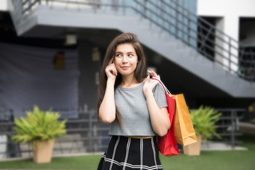 Fototapeta premium Beautiful girl hands hold shopping bag smile and thinking.