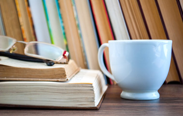 books, library, cup with a drink