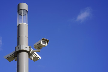 Security camera on blue sky background