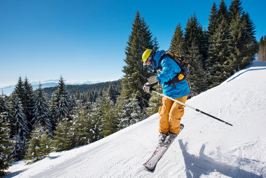 Shot of a skier jumping in the air while riding down the slope in the mountains on a sunny winter day copyspace adrenaline extreme rider activity lifestyle concept