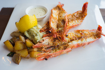 King prawn steak or grilled lobster with lemon sauce.